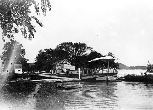 Historic photo of a person on a dock along the waterfront Historic photo of a person on a dock along the waterfront