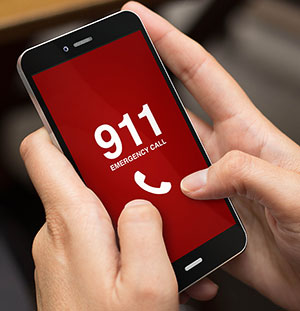 hand on a mobile phone calling 911