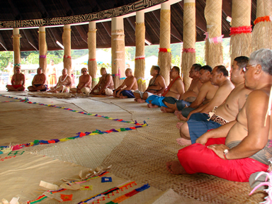 Village matai (chiefs) meet inside a fale (Samoan guest house).