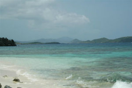 A windswept beach on Saint John showing  Saint Thomas in the distance.