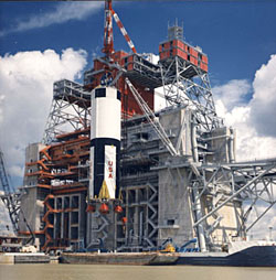 The first stage of the huge Apollo Saturn V moon rocket is lifted by crane 