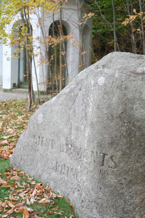 The words SIEUR DE MONTS SPRING are etched into a large boulder, in front of an octagonal structure