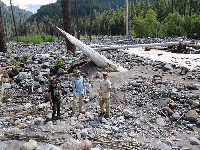 Interns standing in rocky river bed Interns standing in rocky river bed