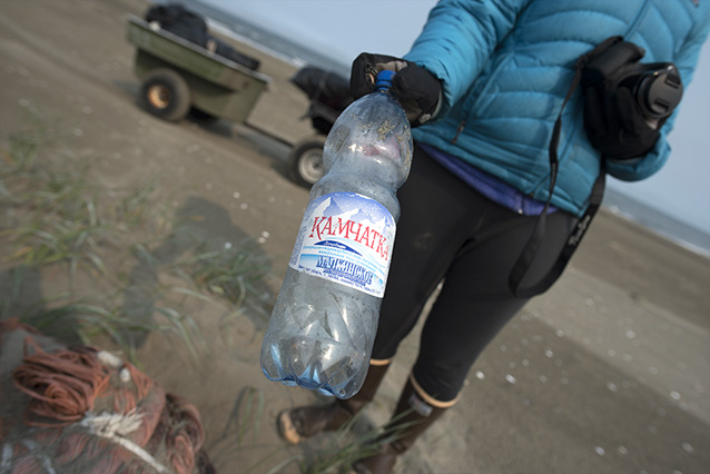 woman holding a disposible water bottle