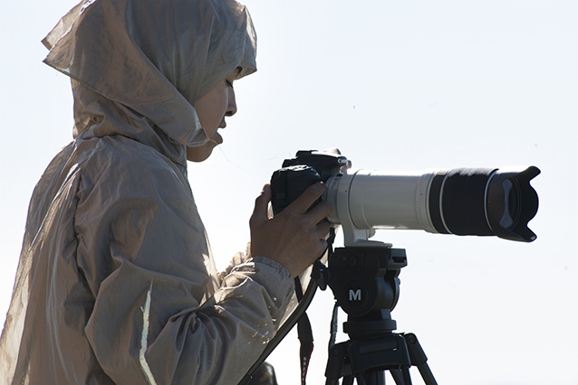 a man setting up a large camera