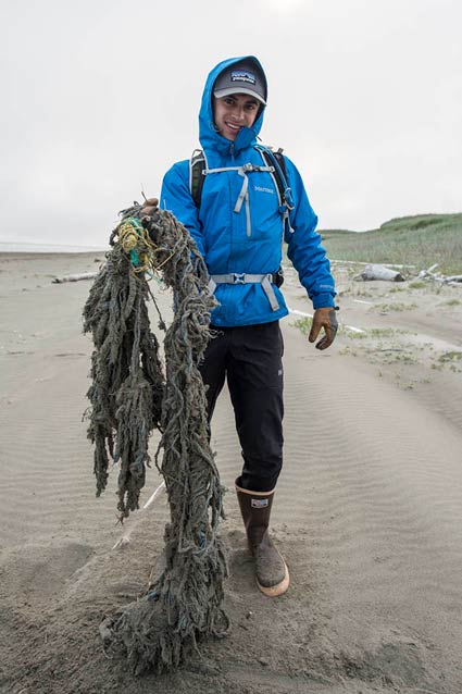a young man holding a large fishing net