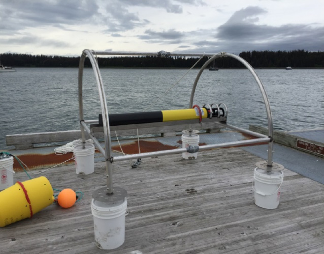 a hoop-house shaped scientific instrument made of metal, plastic and concrete a hoop-house shaped scientific instrument made of metal, plastic and concrete