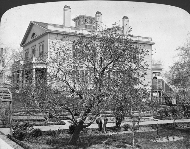 1870s photo of a branching apple tree and garden plots beside large, two story rectangular house 1870s photo of a branching apple tree and garden plots beside large, two story rectangular house