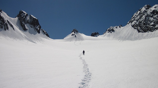 A snowshoer approaches jagged glacial peaks in Olympic National Park (WA) A snowshoer approaches jagged glacial peaks in Olympic National Park (WA)