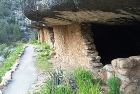 Sinagua cliff dwelling below the canyon rims.