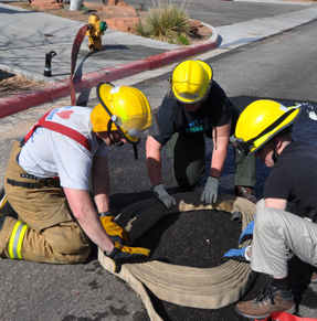 Students practice assembling an attack pack, used for rapid deployment of hose.