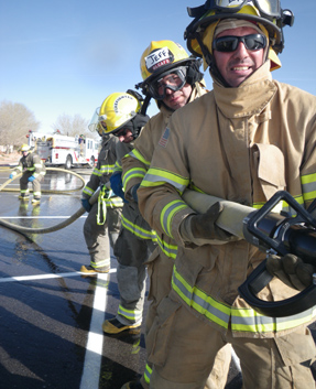 A crew practices maneuvering a large-diameter attack line 