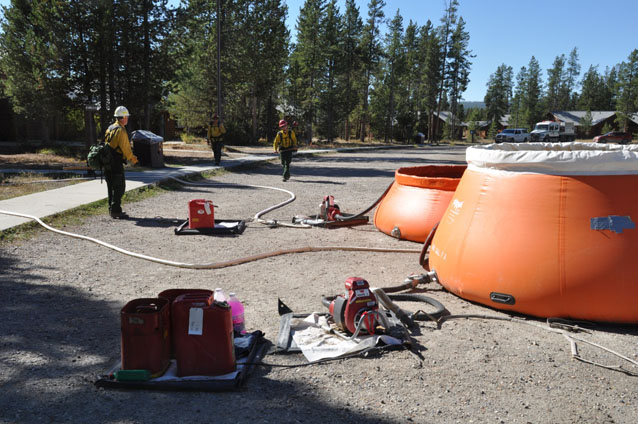 Crews setting up sprinkler systems in the Flagg Ranch housing area. Crews setting up sprinkler systems in the Flagg Ranch housing area.
