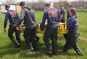 Firefighters carry a litter. Firefighters carry a litter.