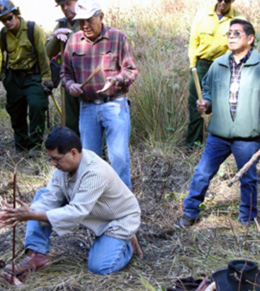 Firefighters engage in a ceremony and traditional methods to ignite a prescribed fire. 