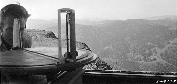 A man looks through an Osborne fire finder