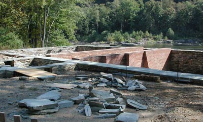 A stabilized brick foundation beside a river was once a mill. A stabilized brick foundation beside a river was once a mill.