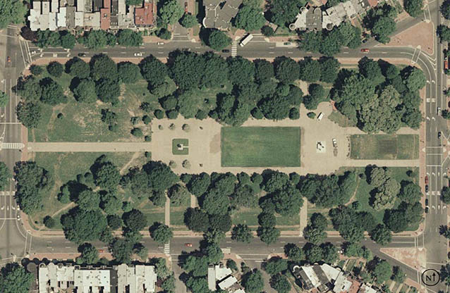 Aerial photo of a city park is a view of walkways, trees, and open lawn from directly overhead.