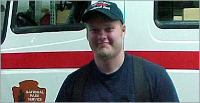 Andy Palmer stands in front of a National Park Service vehicle.