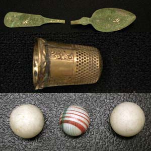 Domestic artifacts like spoons, thimbles, and marbles. Domestic artifacts like spoons, thimbles, and marbles.