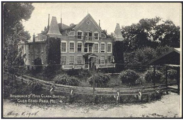 A grainy photo shows a track and a wooden platform wind in front of the yard and house