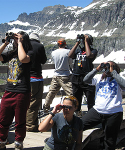 Group of students looking through binoculars