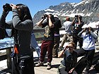 Group of students looking through binoculars