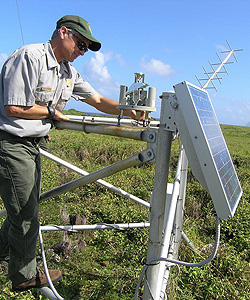 Park ranger working on weather data collection equipment Park ranger working on weather data collection equipment