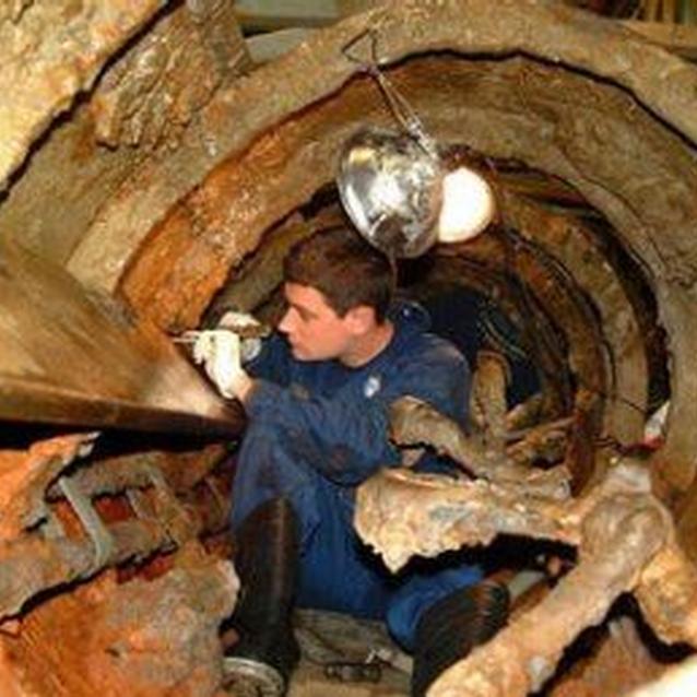 Photo of scientist at work on the H.L. Hunley