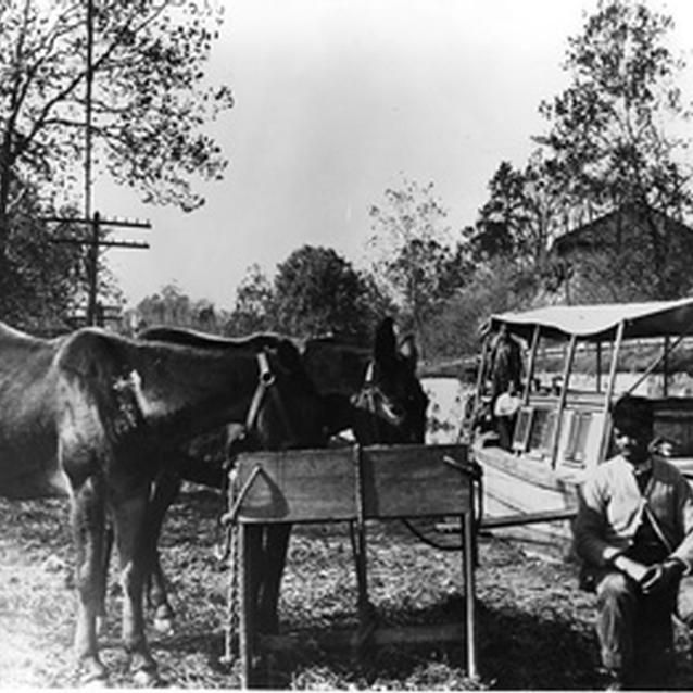 Photograph of Henry Williams and Andrew Jenkins with a canal boat. Photograph of Henry Williams and Andrew Jenkins with a canal boat.