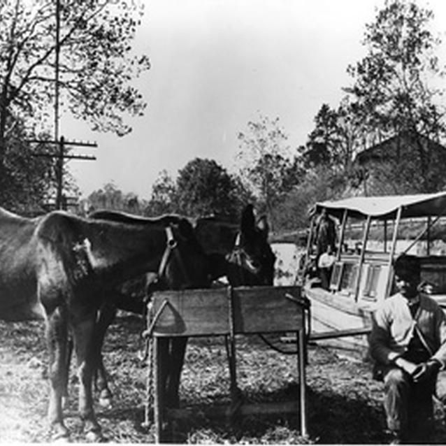 Photograph of Henry Williams and Andrew Jenkins with a canal boat.