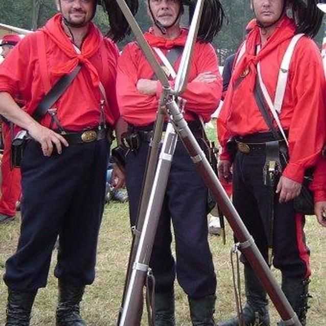 Photo of Garibaldi Guard living historians, in red shirts with black plumed hats. Photo of Garibaldi Guard living historians, in red shirts with black plumed hats.