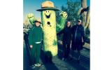 Three people pose with Sunny the Saguaro, the park's mascot