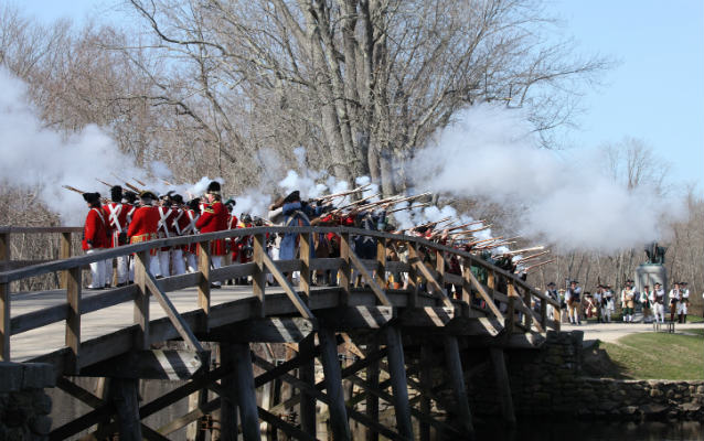 Colonial and American Militia fire a commemorative salute on North Bridge