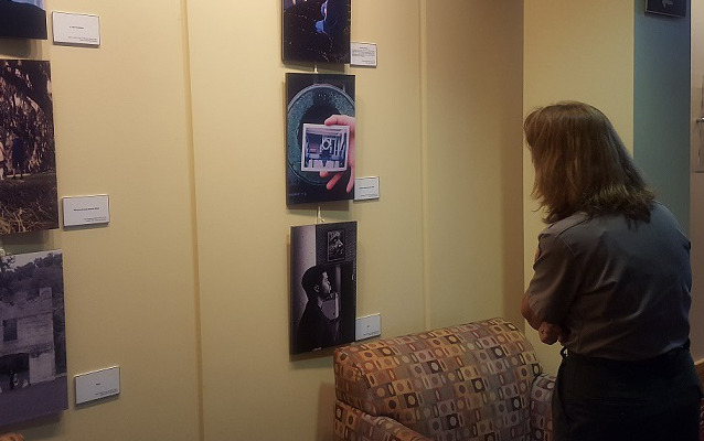 A visitor views the various photos in the exhibit.