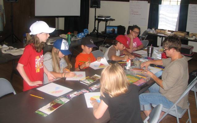 Youth artists working around a table