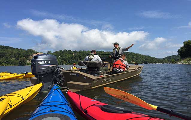 John McCutcheon speaks to paddlers about law enforcement on Moccasin Bend.