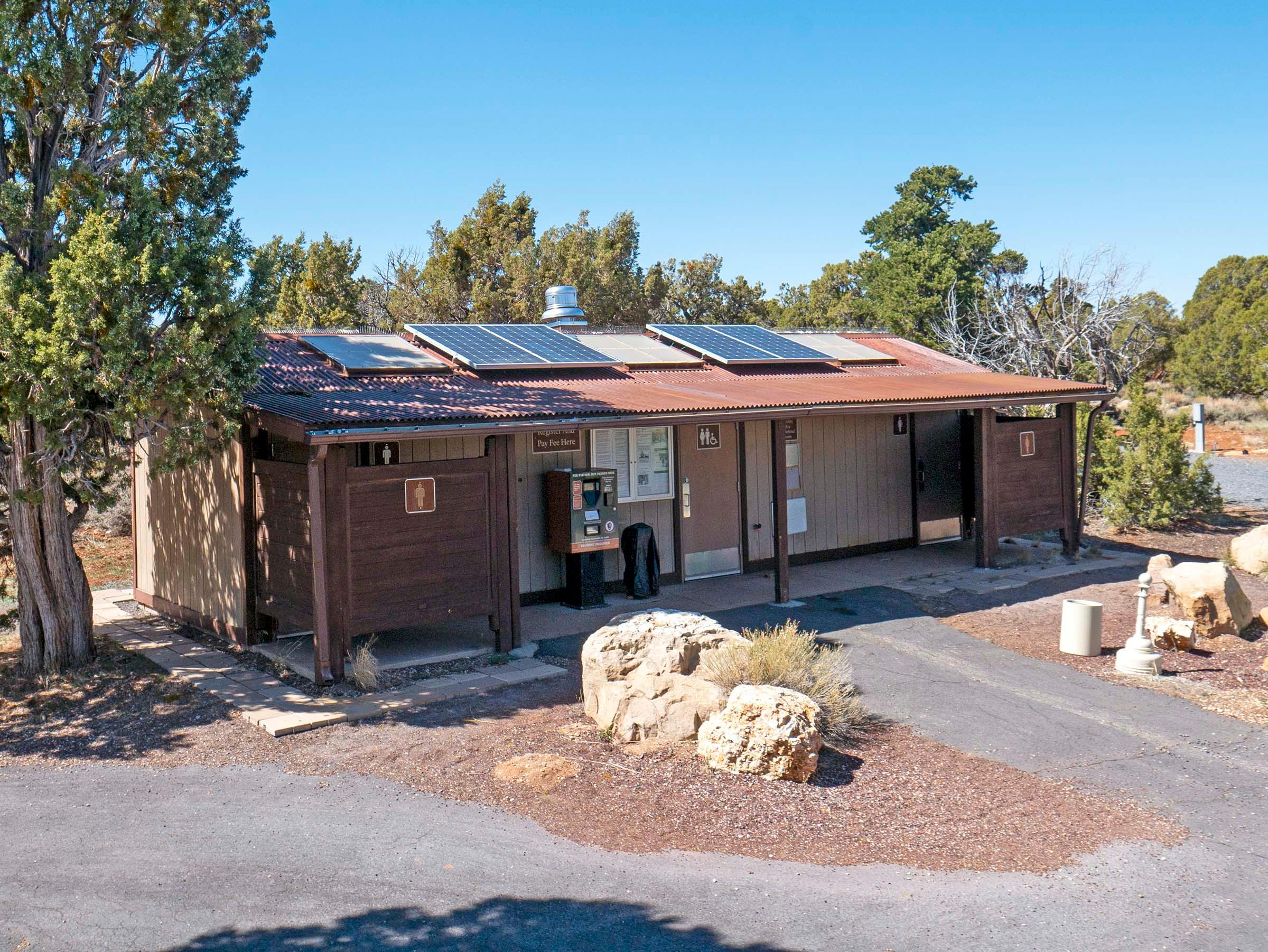 Single story restroom building with men's side on the left and women's on the right.