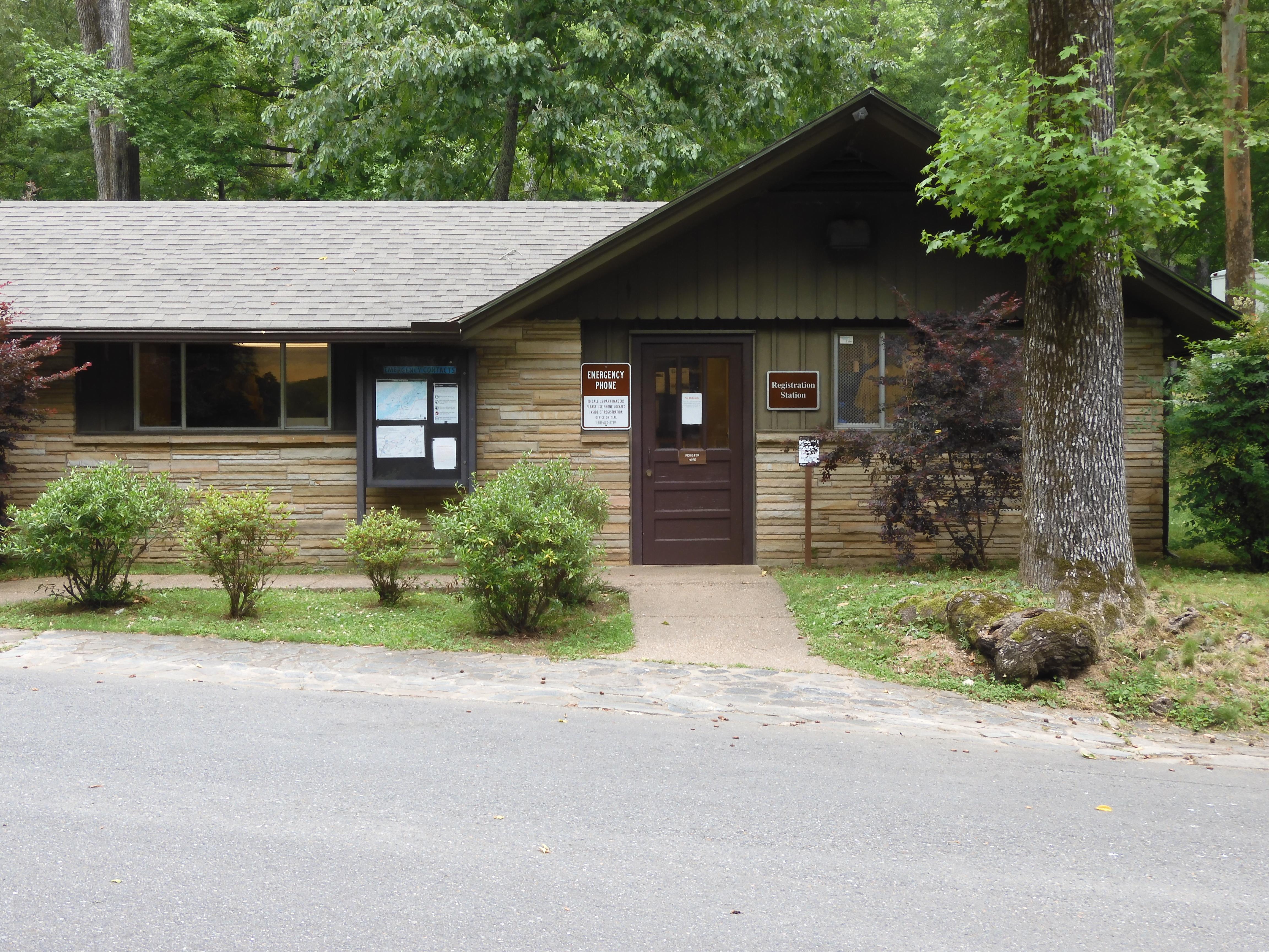 The tan brick, ranch style building houses the campground's fee station and community bulletin board