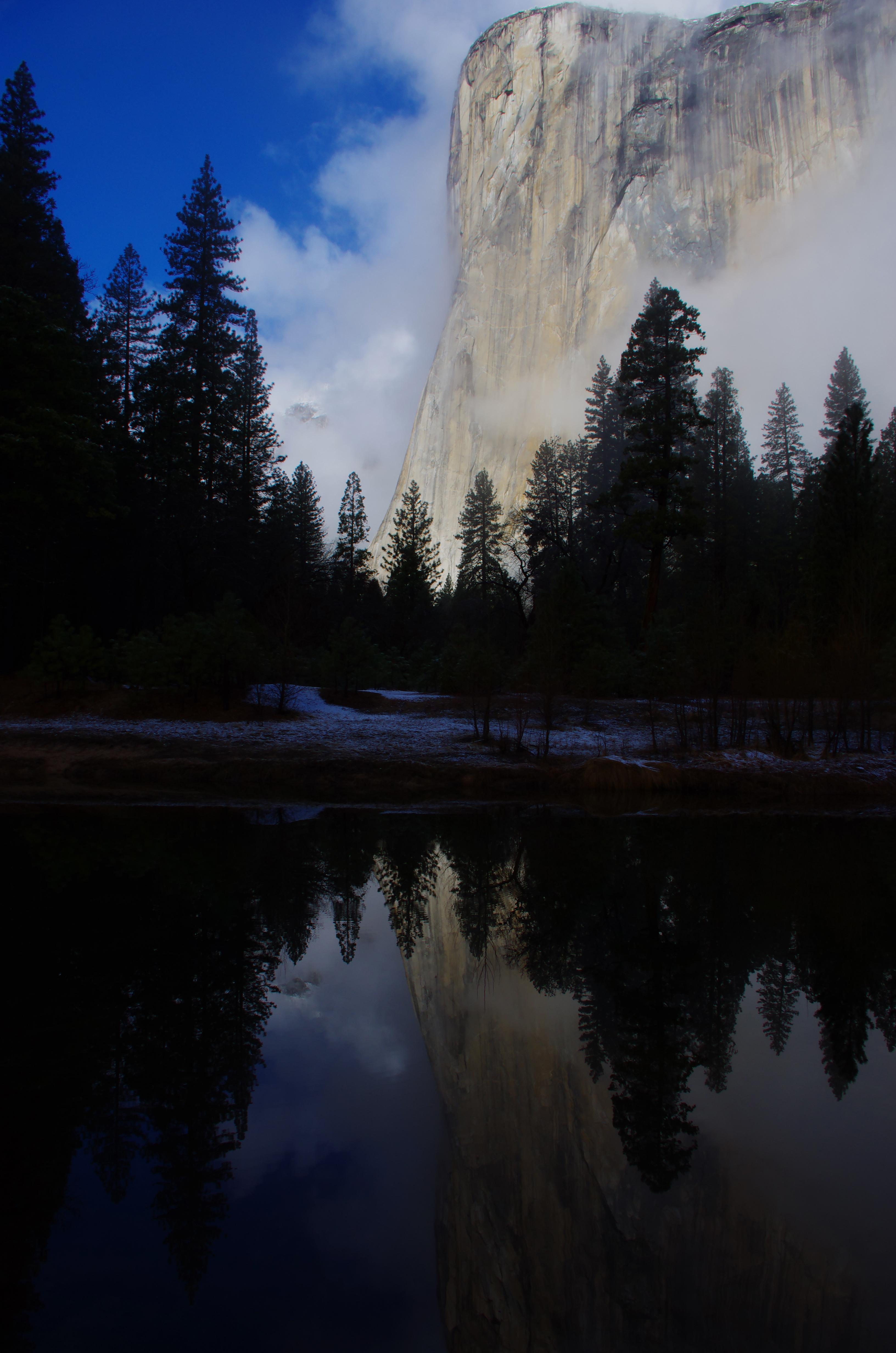 El Capitan and reflection in Merced River with some low clouds