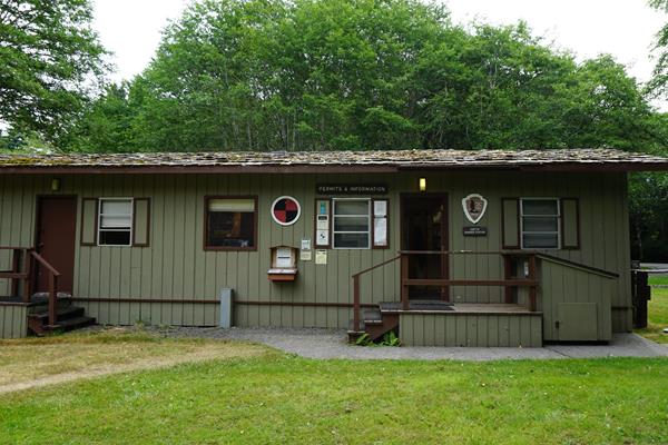 A simple, one-story building with the National Park Service arrowhead logo and signage.