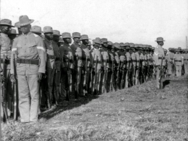 A long row of African American soldiers standing at attention