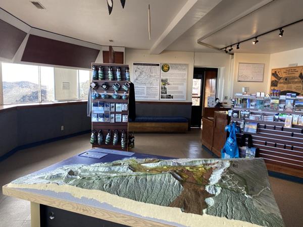 Interior of a visitor center with a 3D model of the mountain in the foreground.