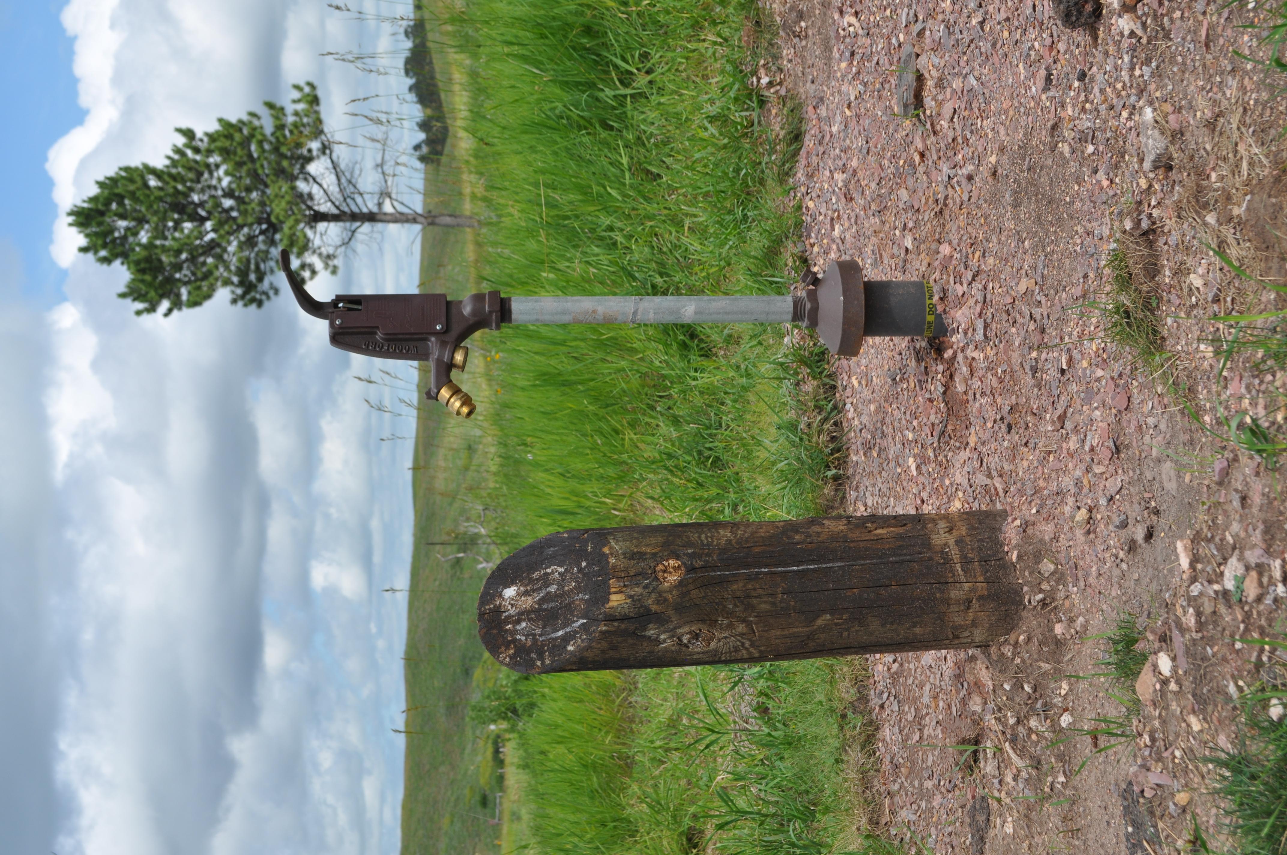 A water spigot at the side of the road.