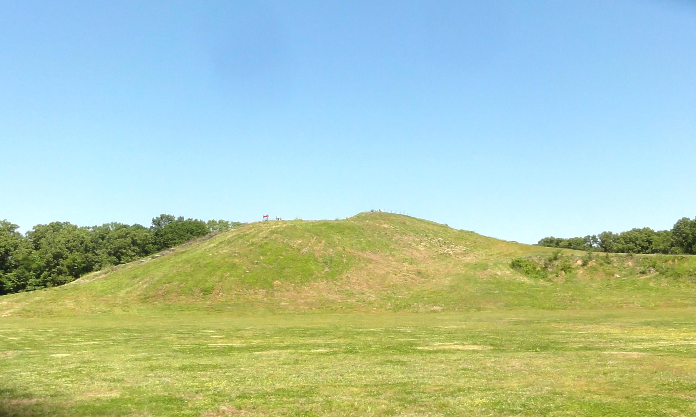 A grassy green mound.