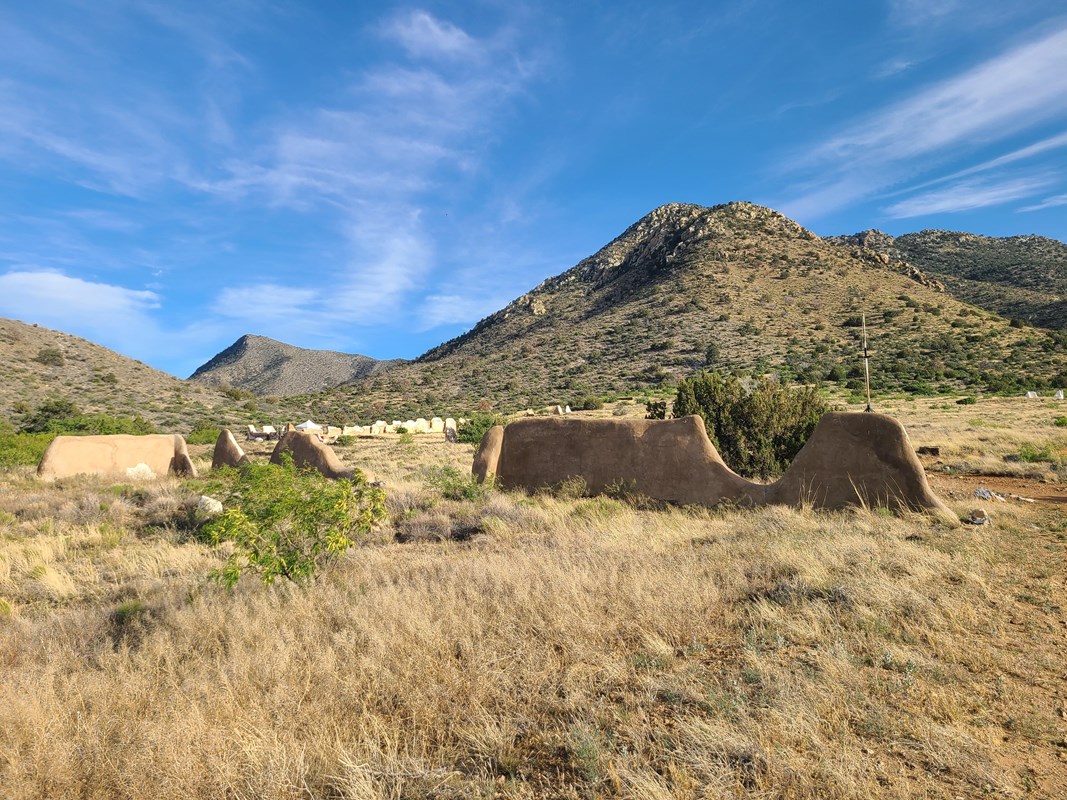 Ruins of the fort with mountains and valley in the background.