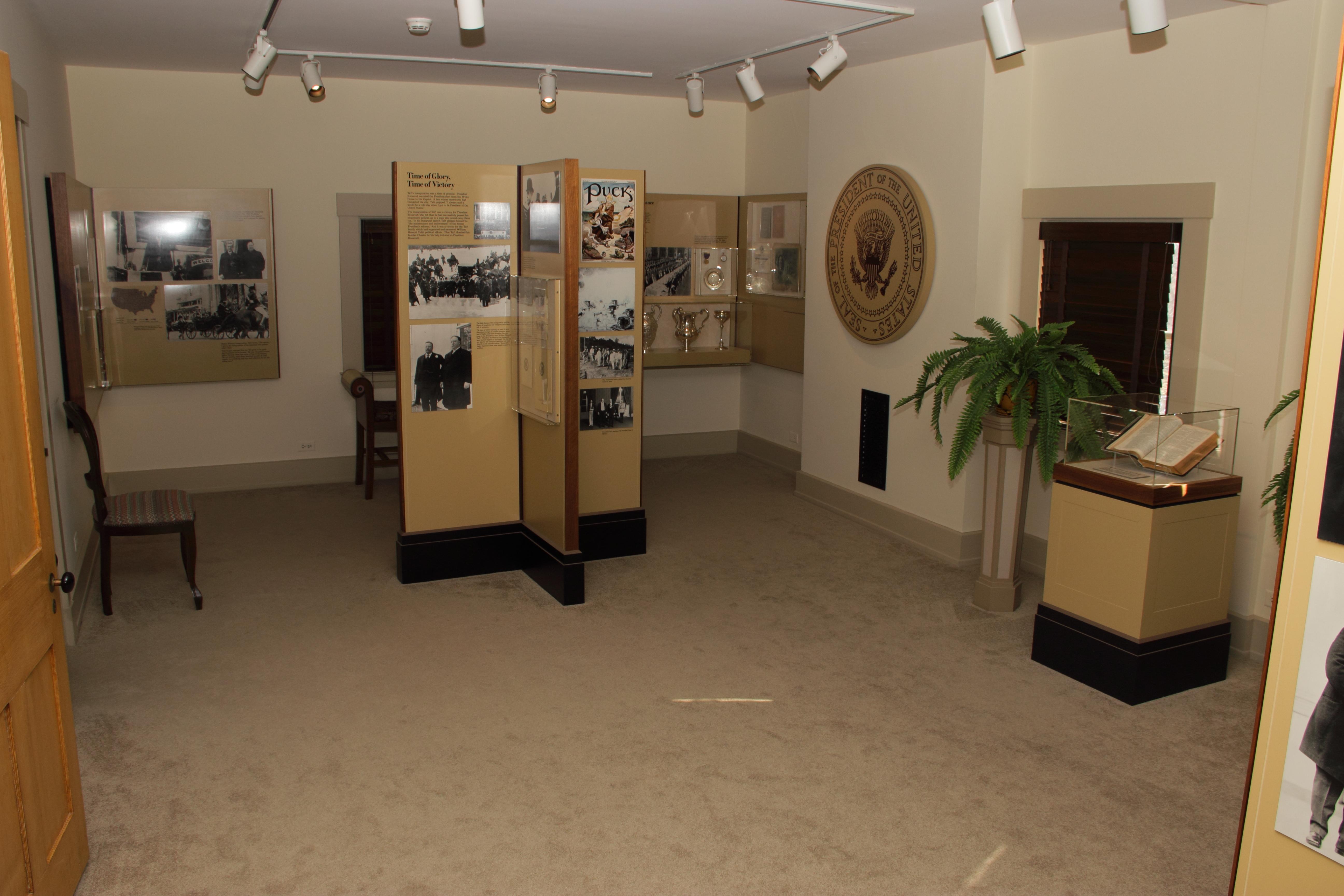 A large room with individual columns of artifacts and display items in the center and wall displays