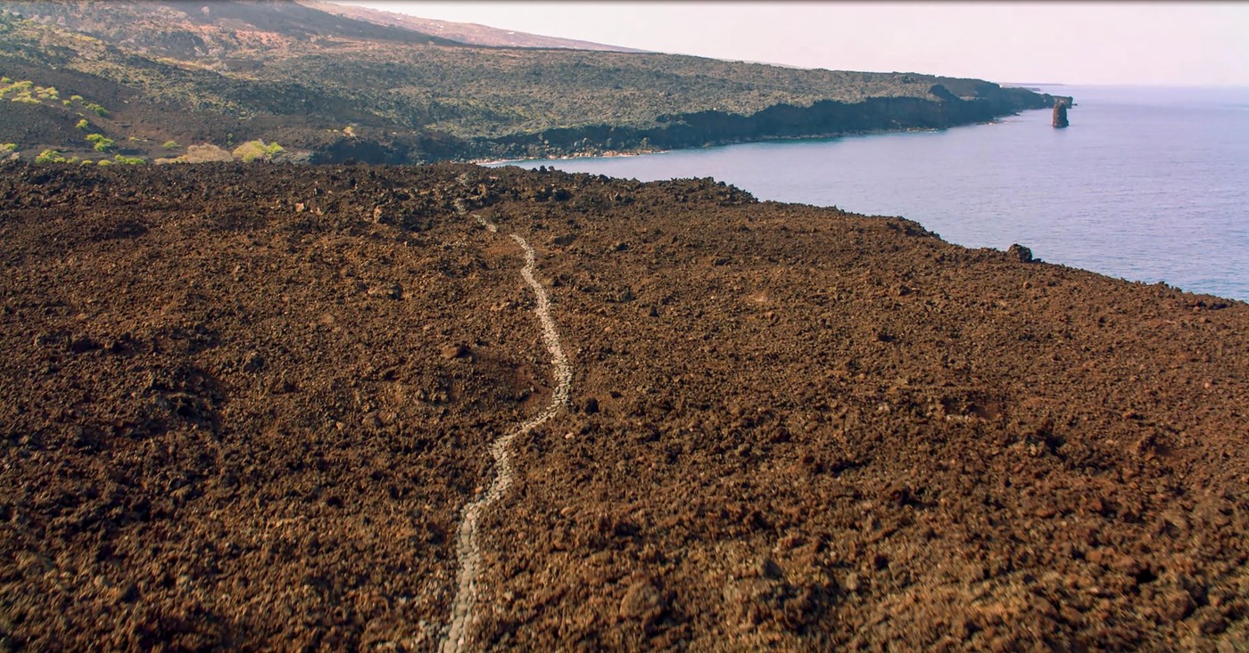Aerial photograph of trail through lava along the Hawaiian Coast