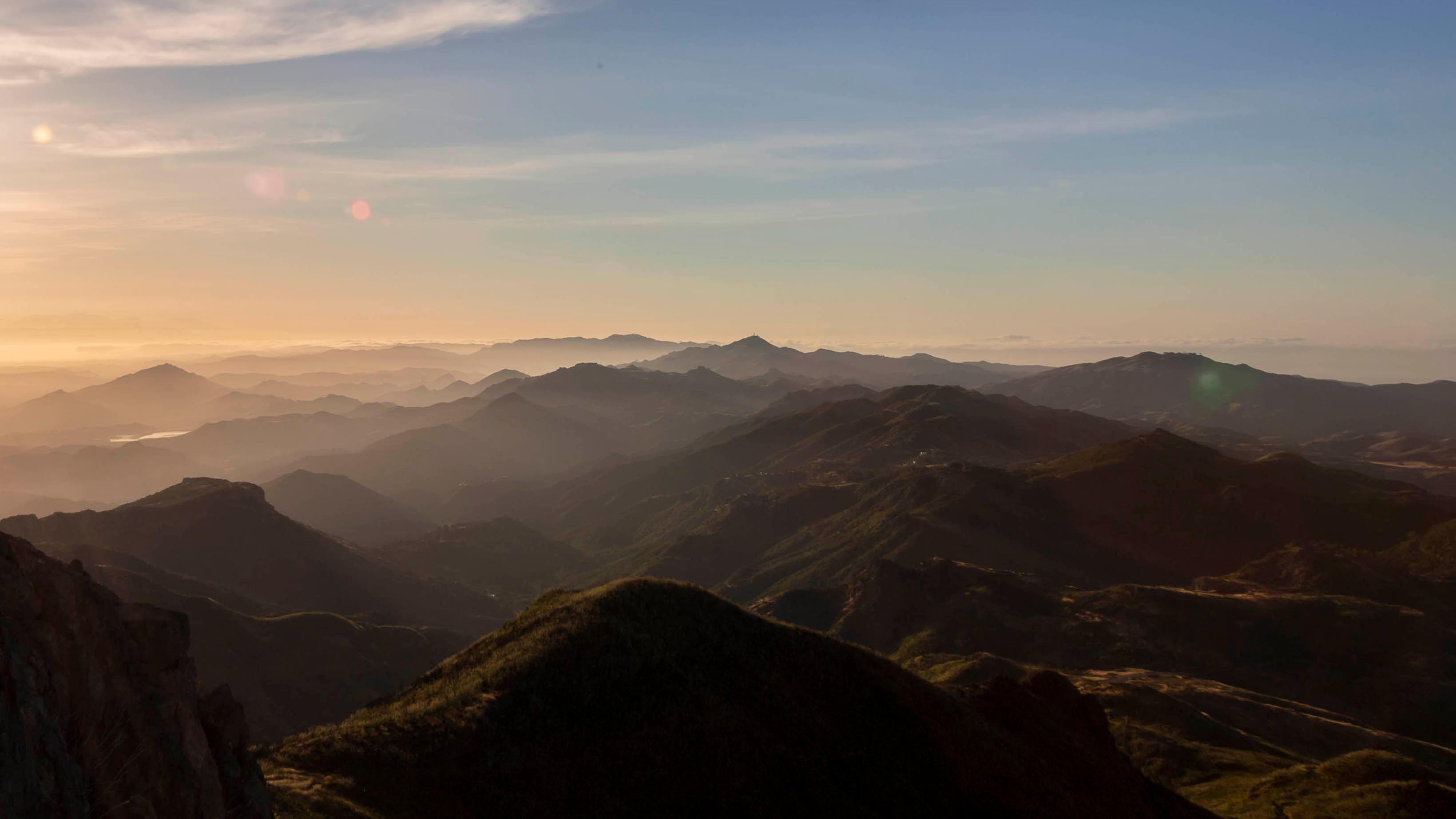 Mountain silhouettes at sunrise.