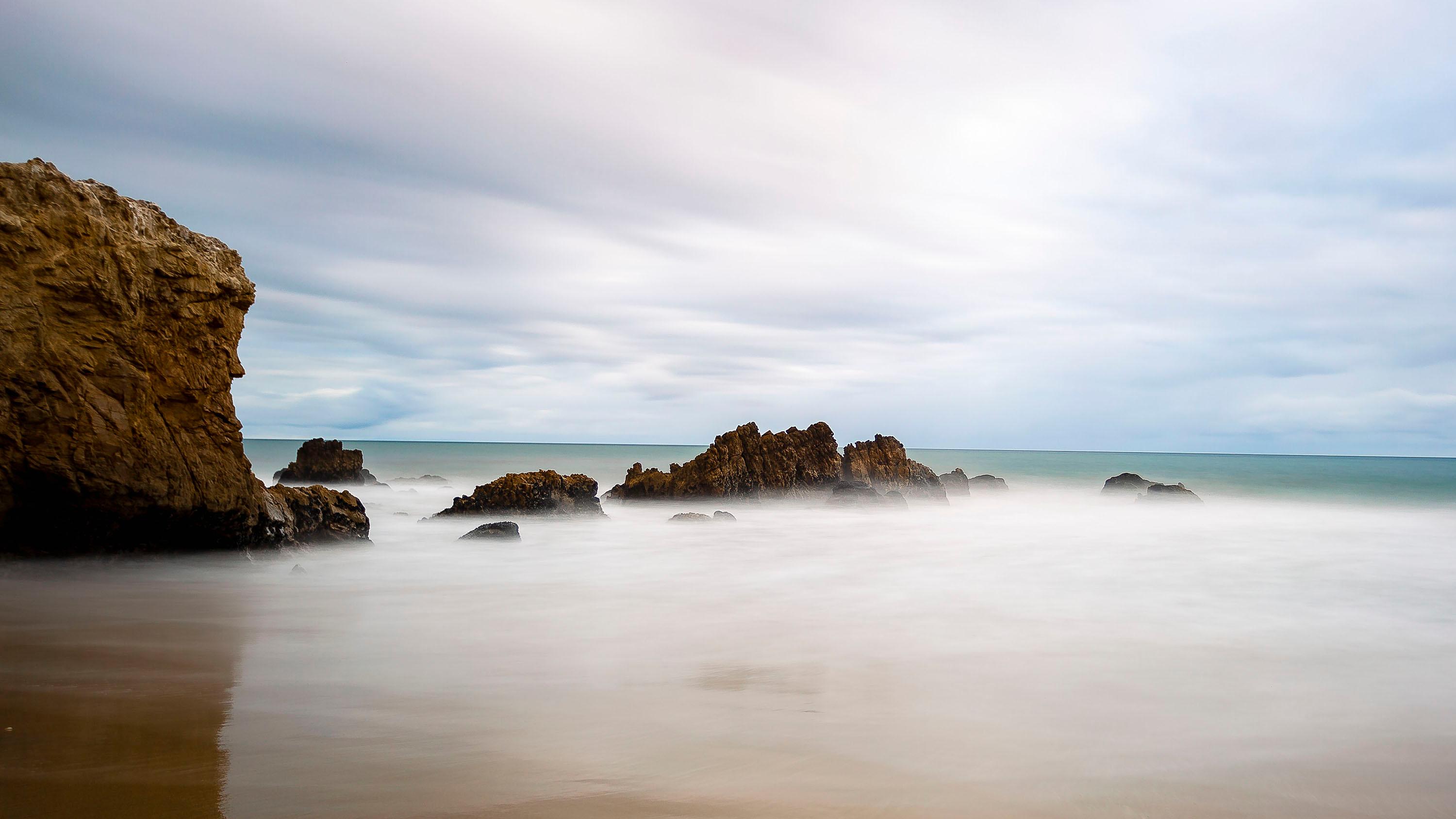 Rocks emerging from ocean.